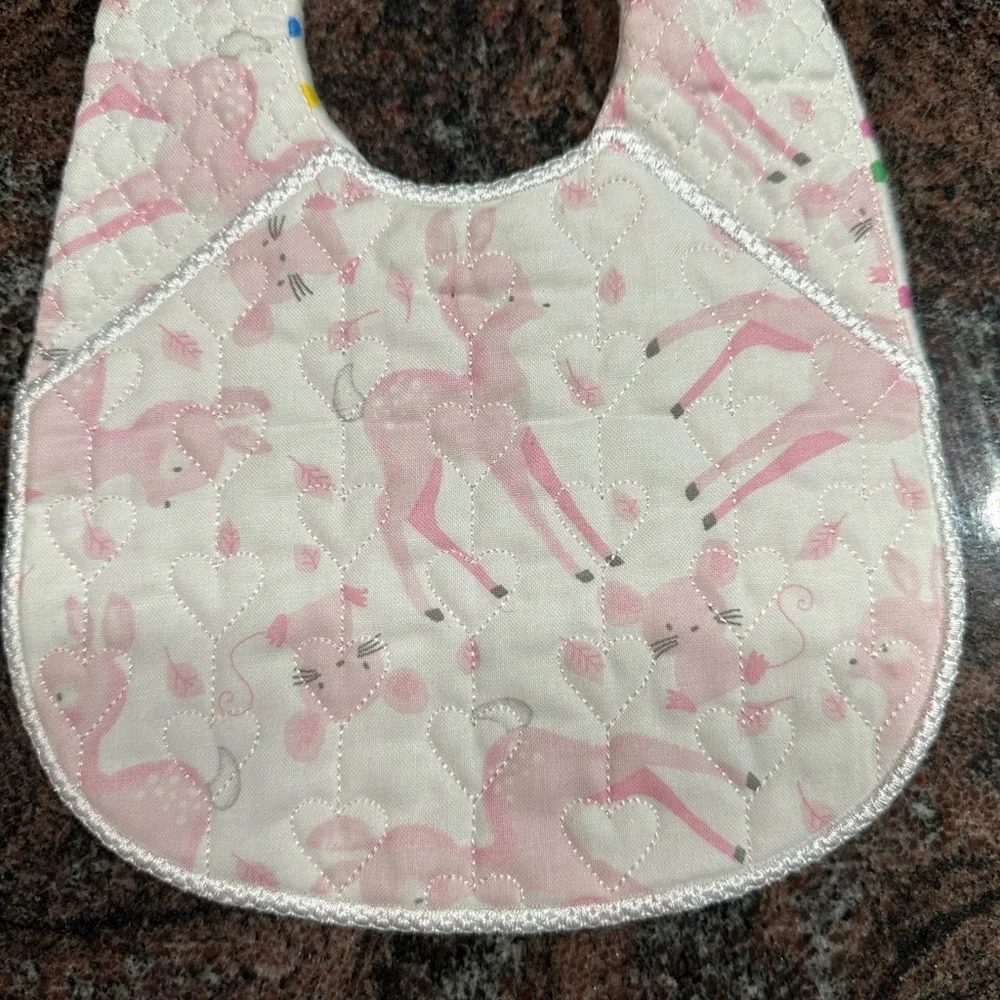 Handmade reversible quilted baby bib in pink deer print